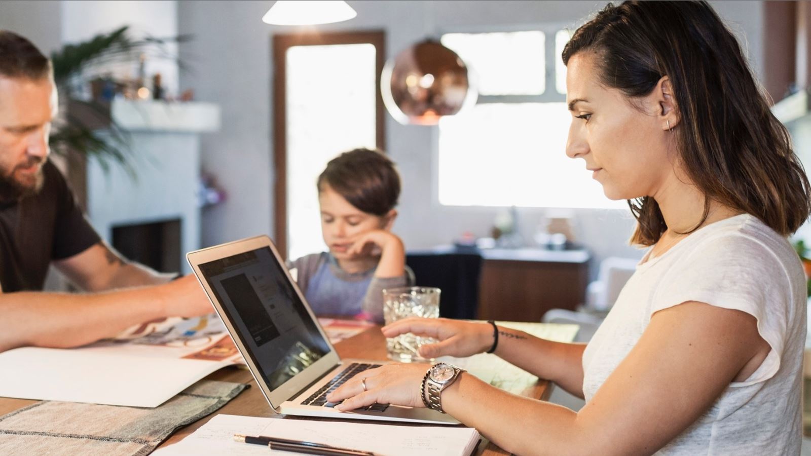 Family working remotely at dining table