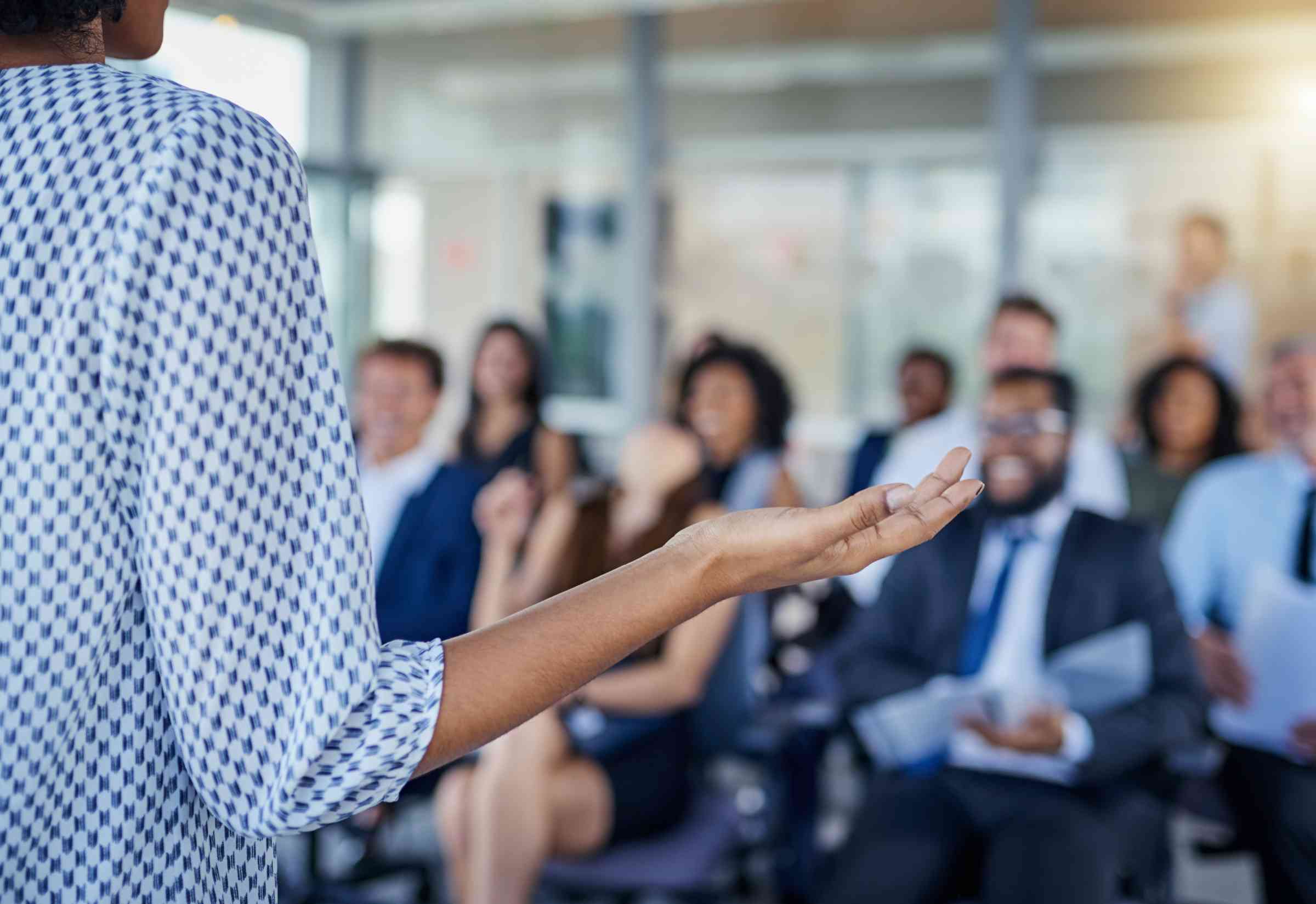 Speaker delivers presentation to seated colleagues