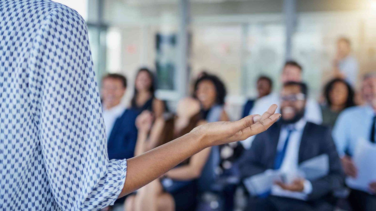 Speaker delivers presentation to seated colleagues
