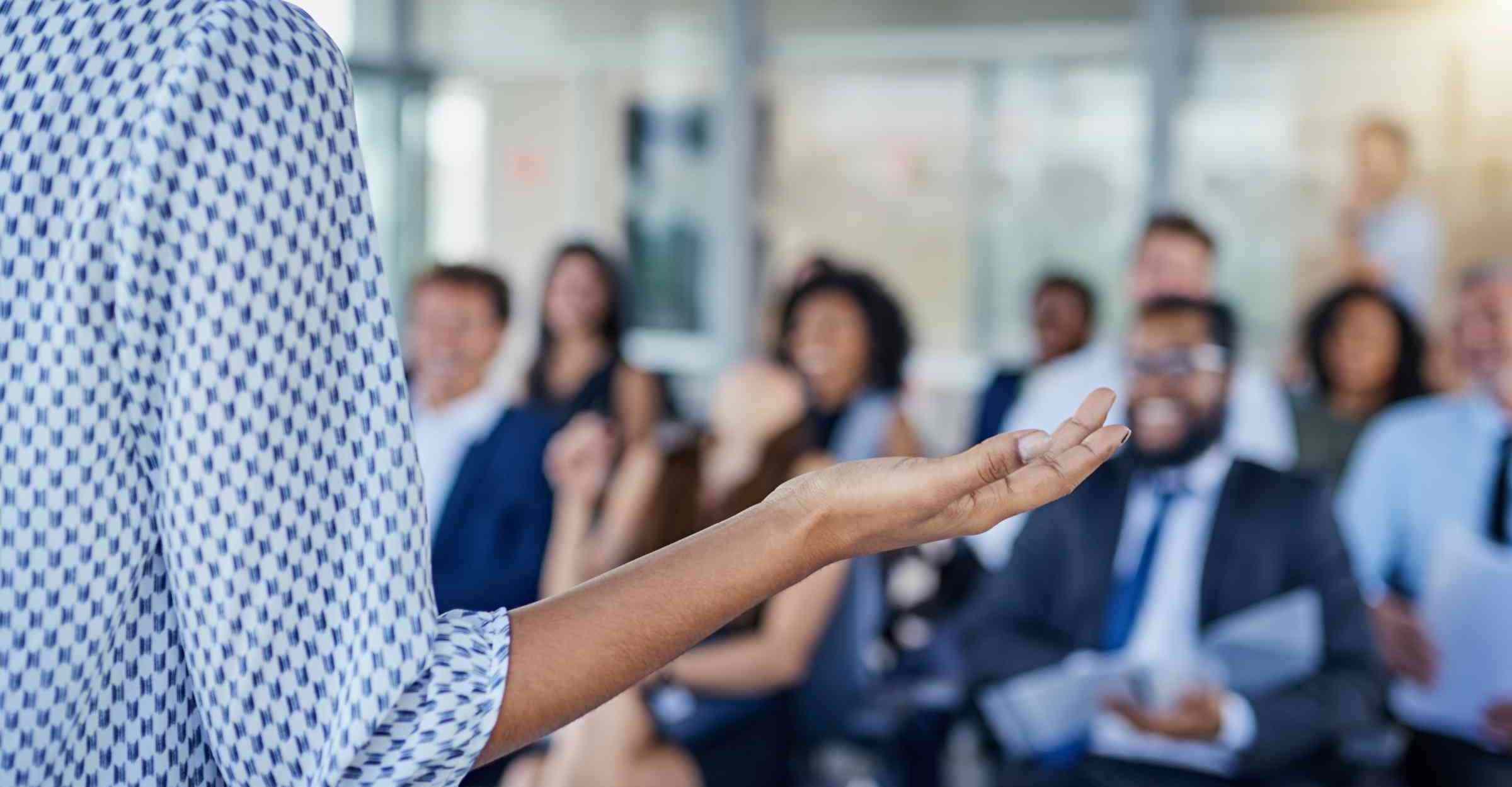 Speaker delivers presentation to seated colleagues