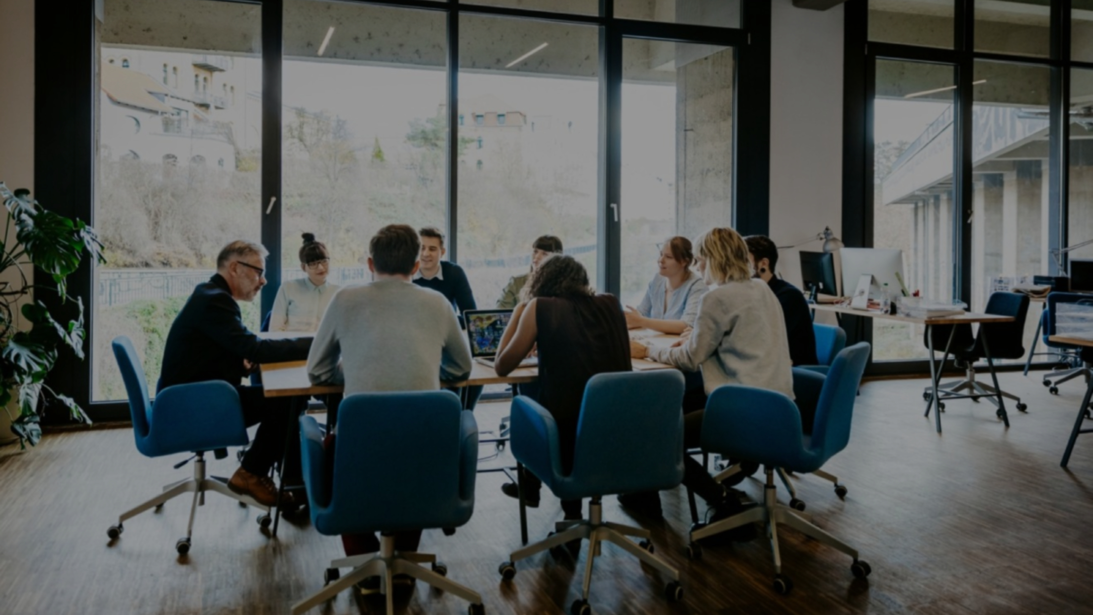 New business meeting with a group of entrepreneurs on a conference table in a modern office loft
