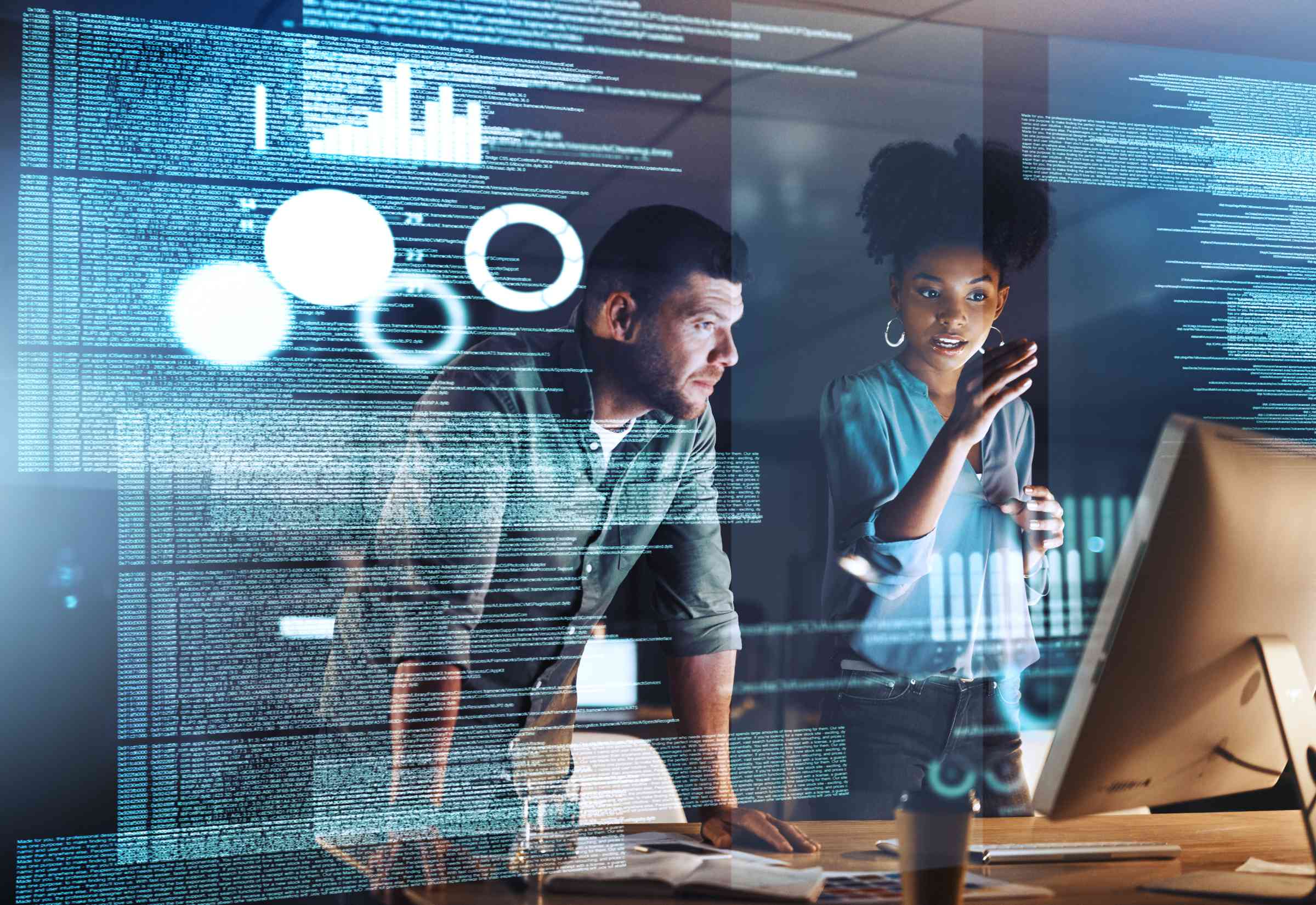Two colleagues studying a computer screen
