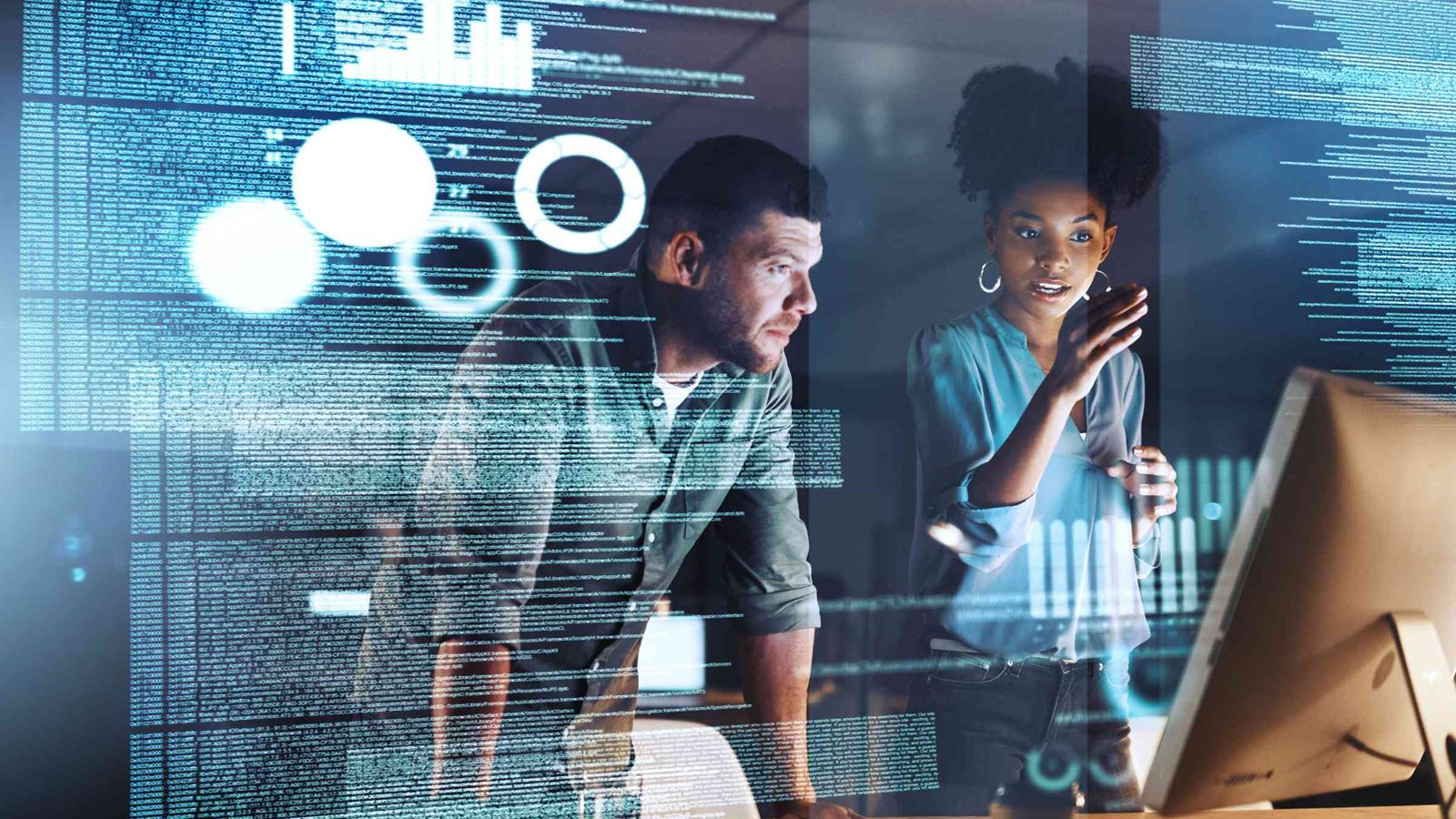 Two colleagues studying a computer screen
