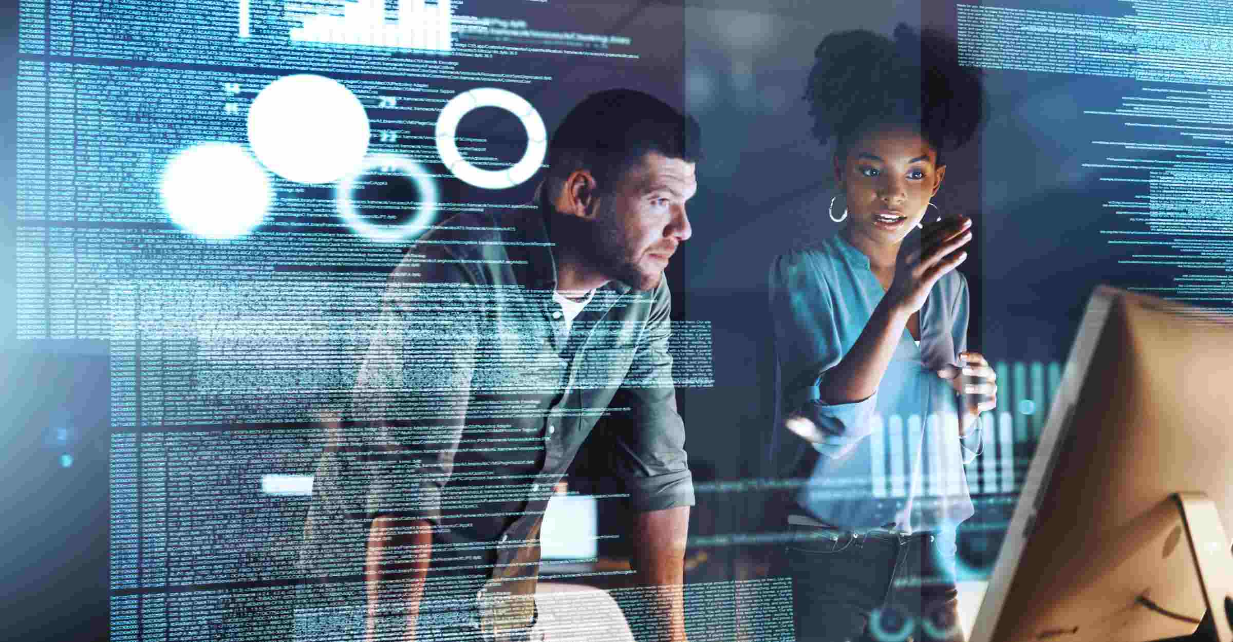 Two colleagues studying a computer screen