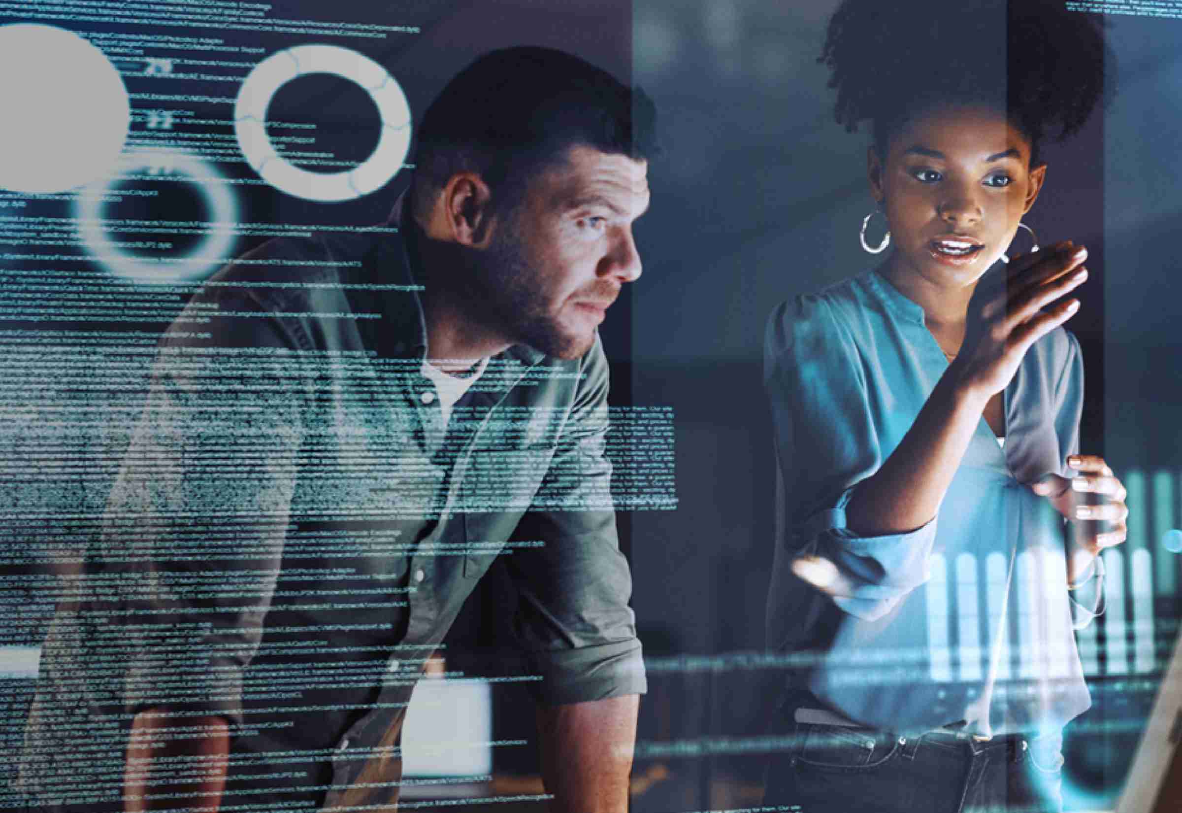 Male and female reviewing source codes in front of a screen
