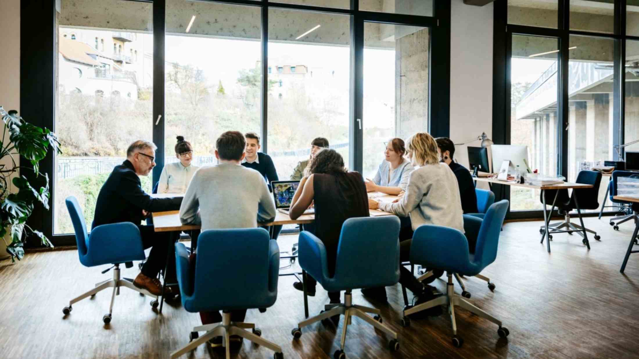 New business meeting with a group of entrepreneurs on a conference table in a modern office loft