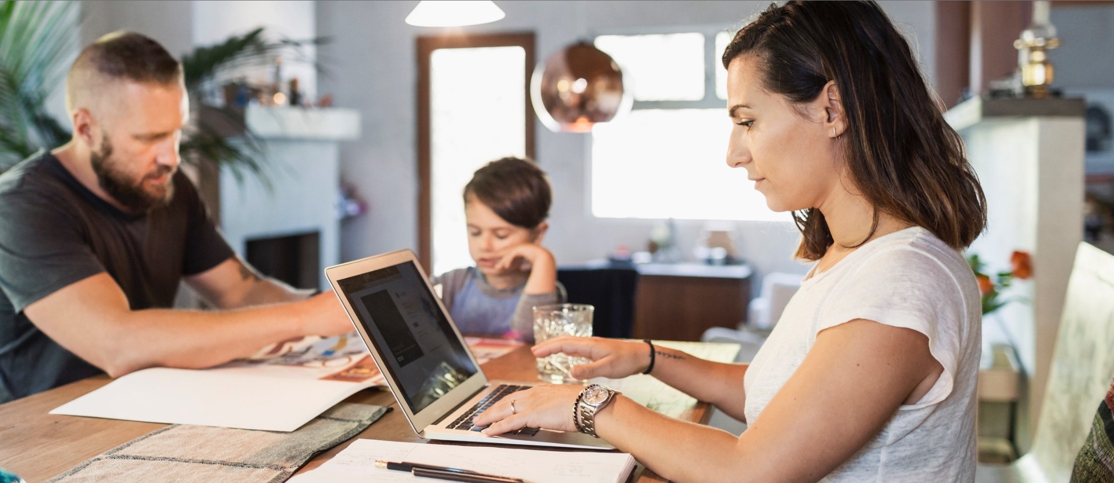 Family working remotely at dining table