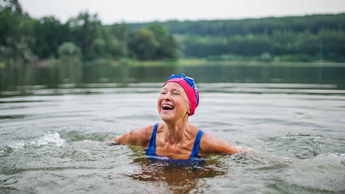 portrait of a senior woman swimming in a lake