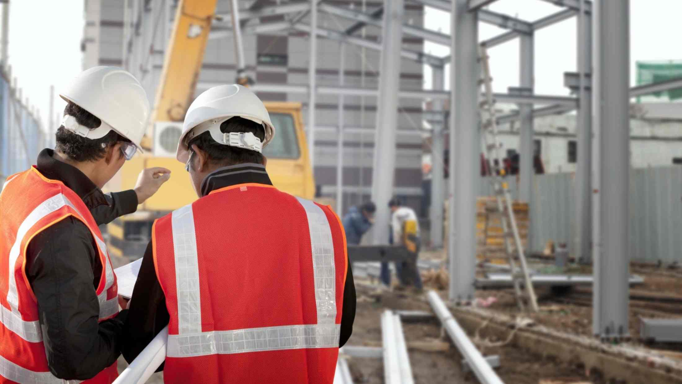 Two foremen discussing on construction site