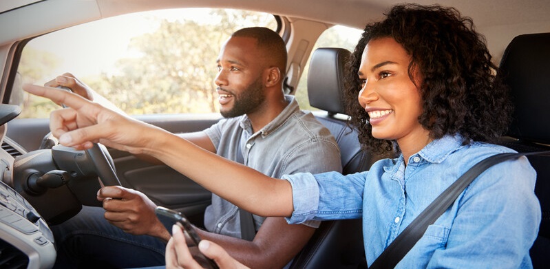 man and woman in car driving
