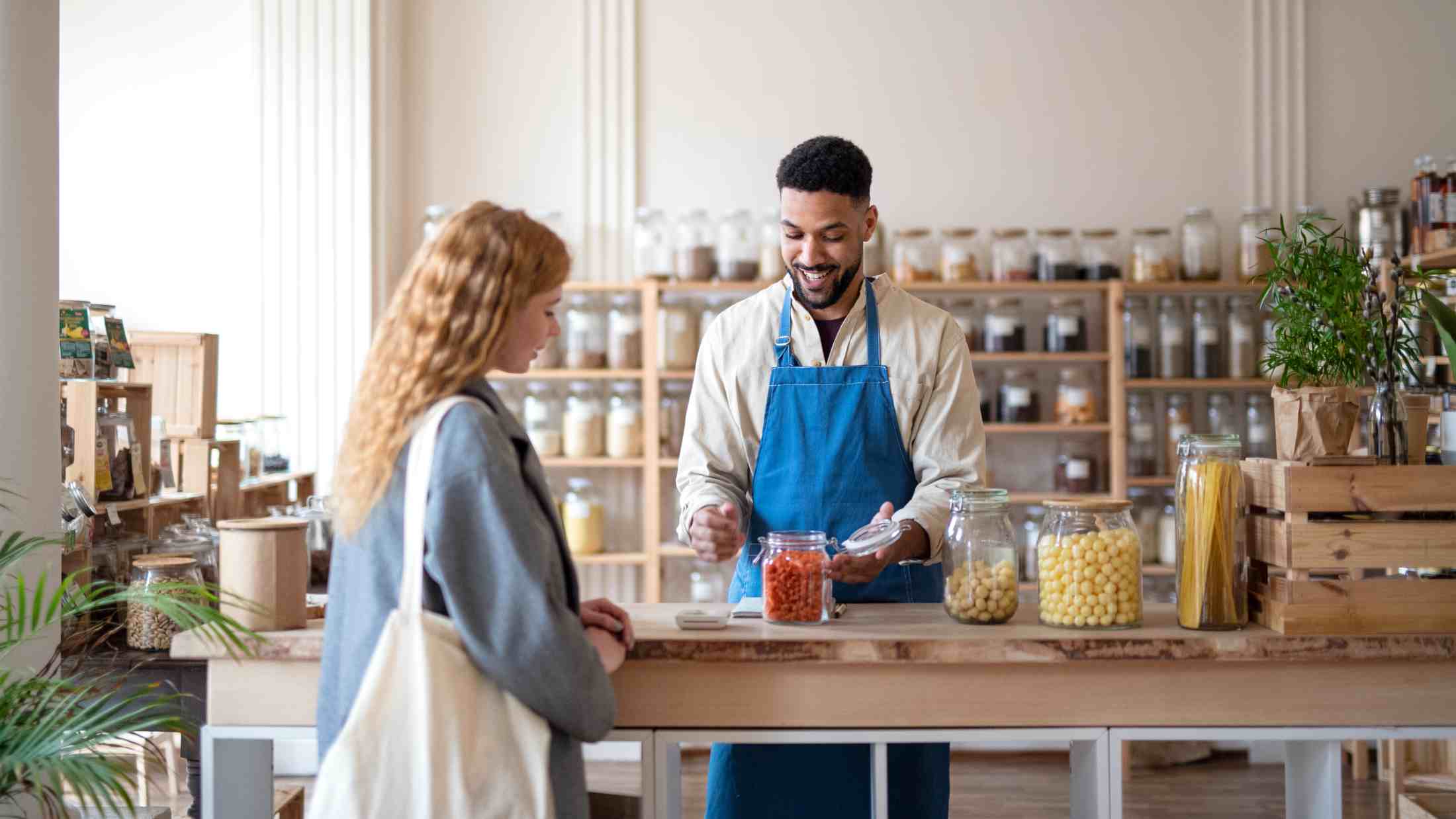 Shop assistant serving a customer in a food shop
