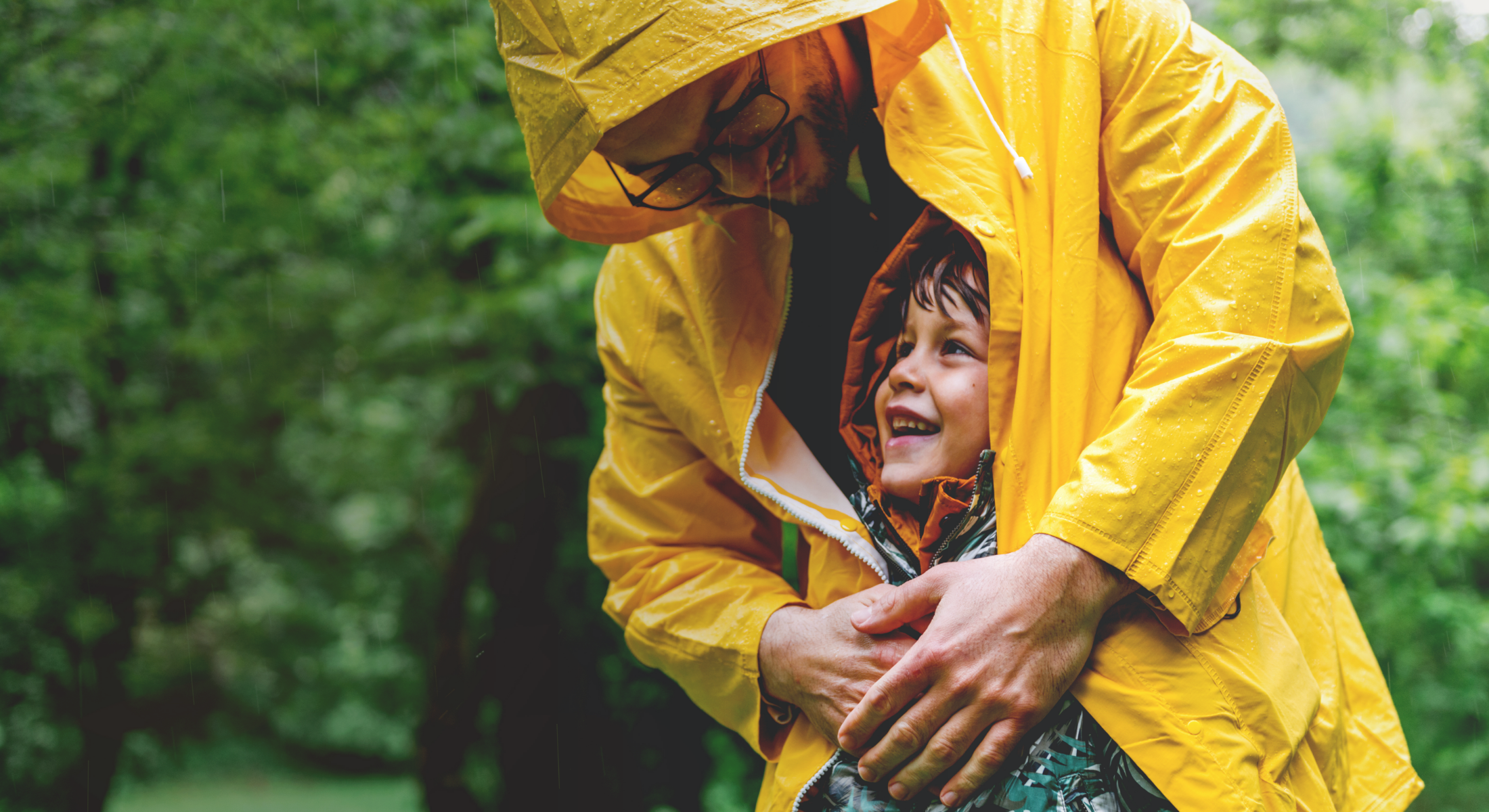 Father and son play in the rain