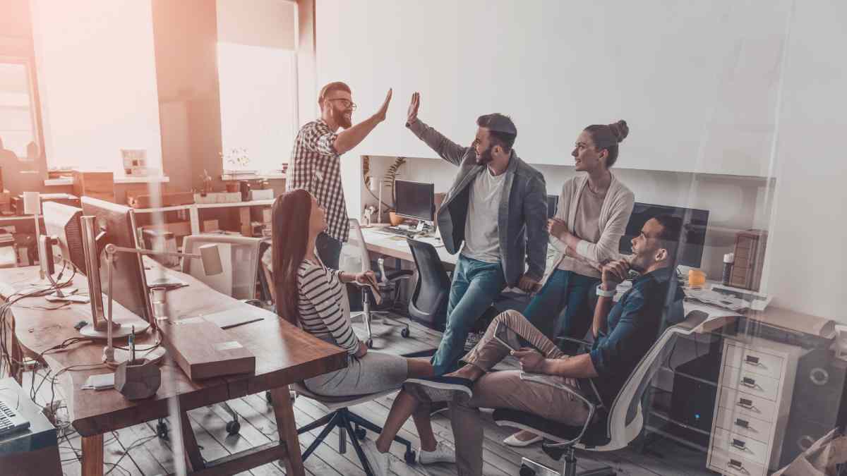 Team high-fiving in and office