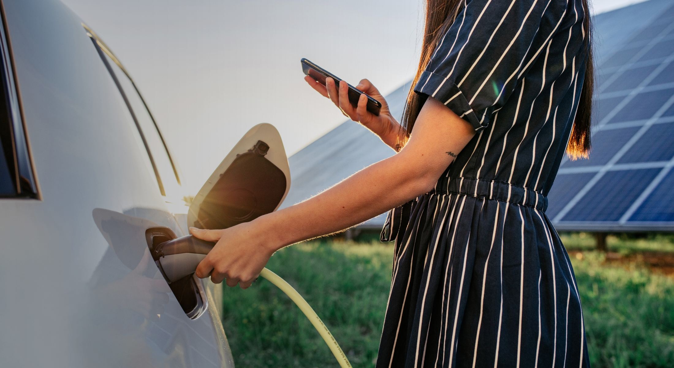 Person charges an electric vehicle