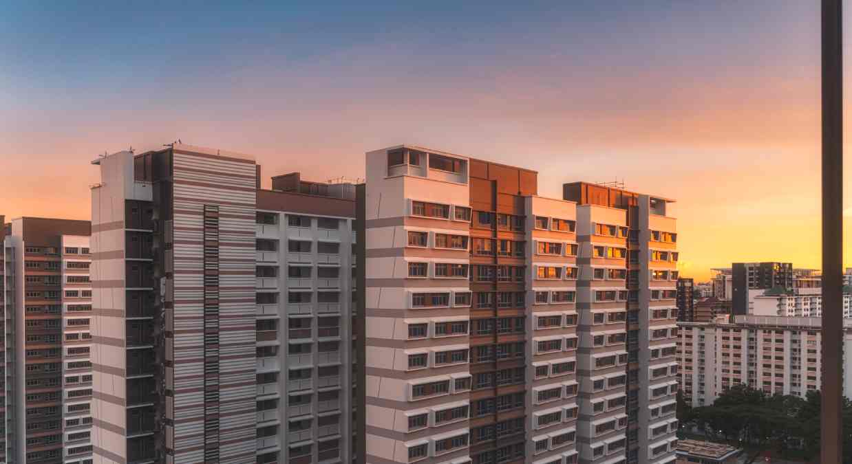 High rise buildings with cladding on and a sunset behind