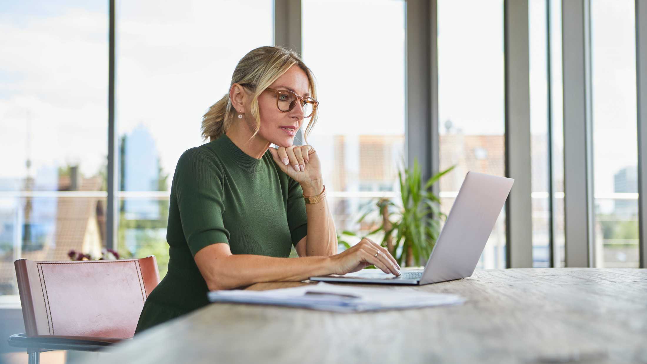 Woman in an office working on a laptop