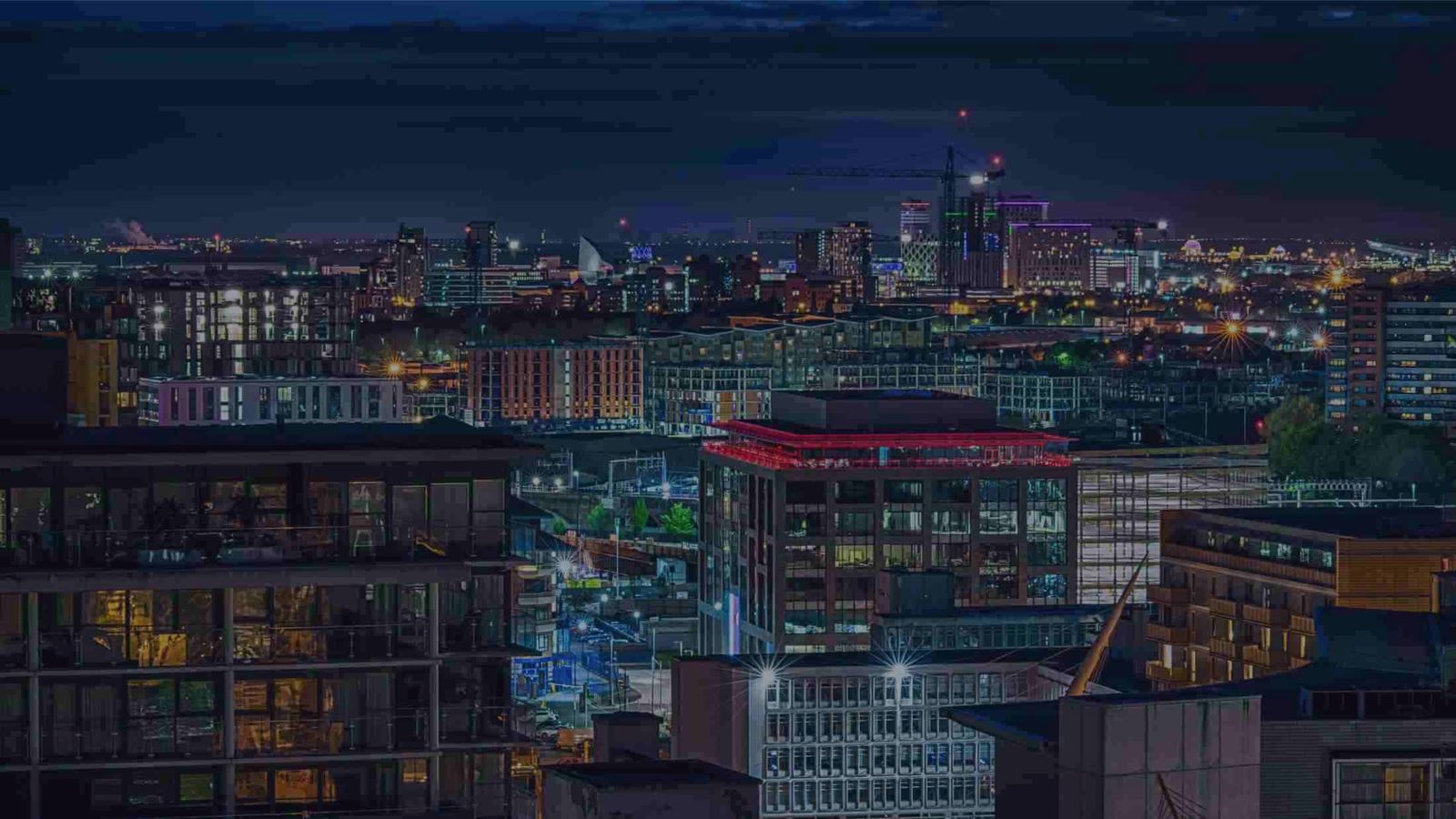manchester city scape by night - tall office buildings w