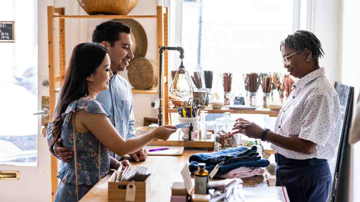 Small business shop owner serving customers